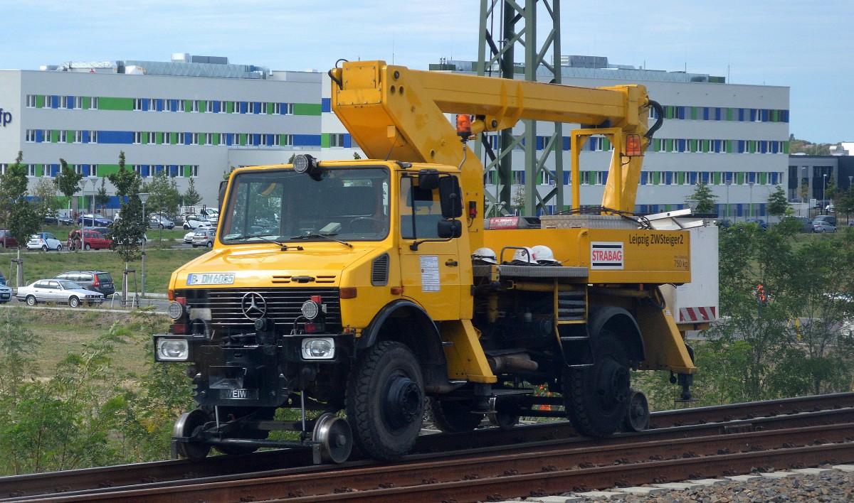 Diverse Zweiwegefahrzeuge sind im Moment beim Neubau der Fernbahnstrecke zwischen Berlin-Lichtenberg und Berlin Grünauer Kreuz zu beobachten Gleis- und Hochleitungsarbeiten machen endlich sichtbare Fortschritte, hier von STRABAG ein MB UNINMOG (Leipzig ZWSteiger2) mit hydraulischer Hebebühne als Aufbau am 16.09.15 Höhe Berlin Adlershof. (Bild aus dem S-Bahnfenster).