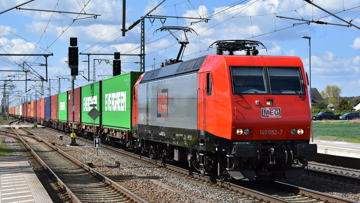 MEG - Mitteldeutsche Eisenbahn GmbH, Schkopau [D] mit der gemieteten  145 052-7  [NVR-Nummer: 91 80 6145 052-7 D-DB] und einem Containerzug am 21.04.26 Höhe Bahnhof Rodleben.